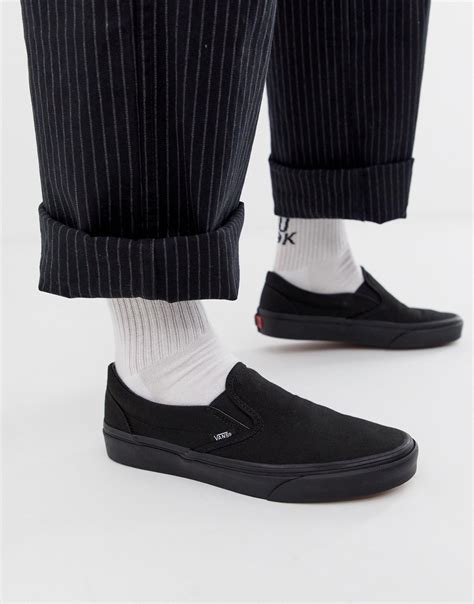 black vans slip on|solid black slip on vans.